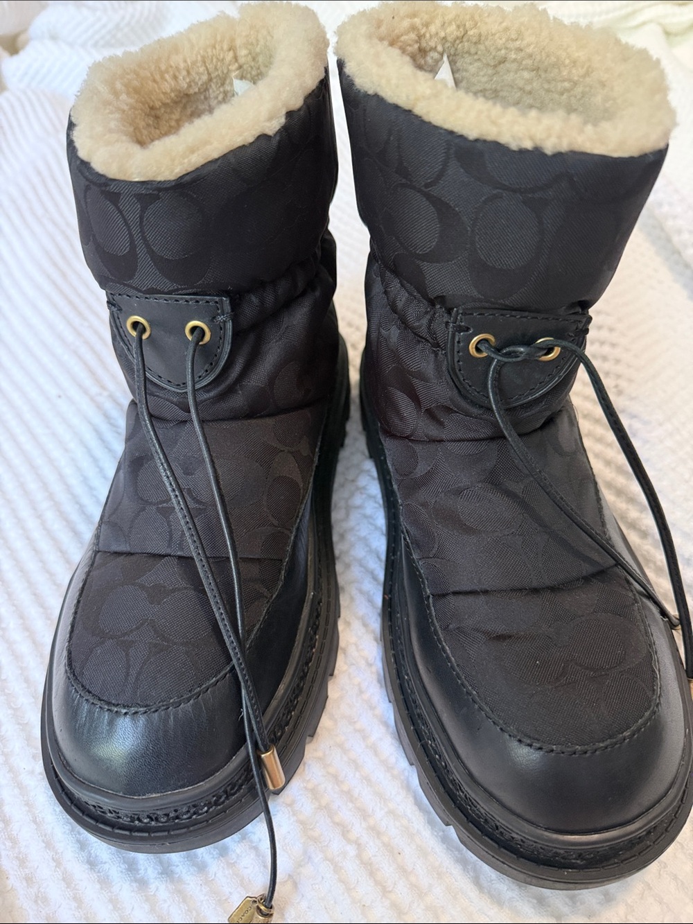 The Coach Kailee Nylon Bootie in black features a cozy shearling-lined collar